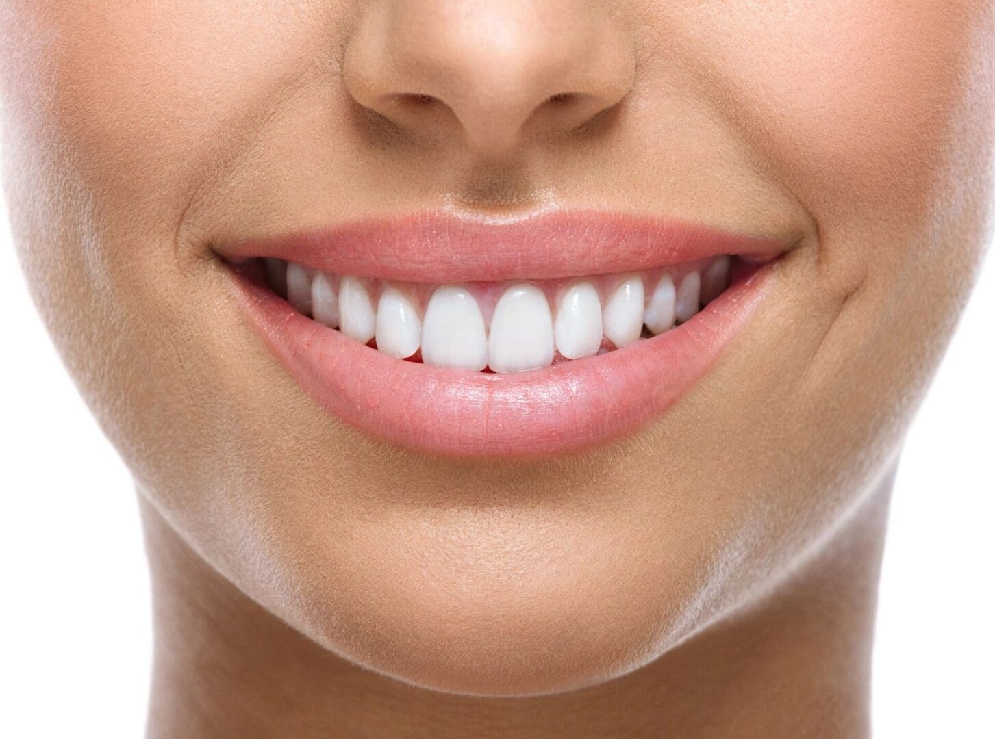 A woman with white teeth smiling for the camera.